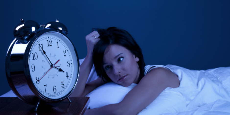 tired woman starting at clock